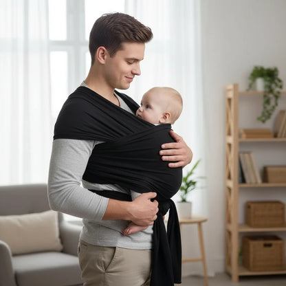 papa qui porte son bébé avec écharpe de portage noire